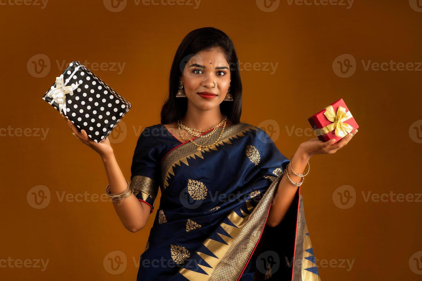 Portrait of young happy smiling woman or Girl holding gift box. photo