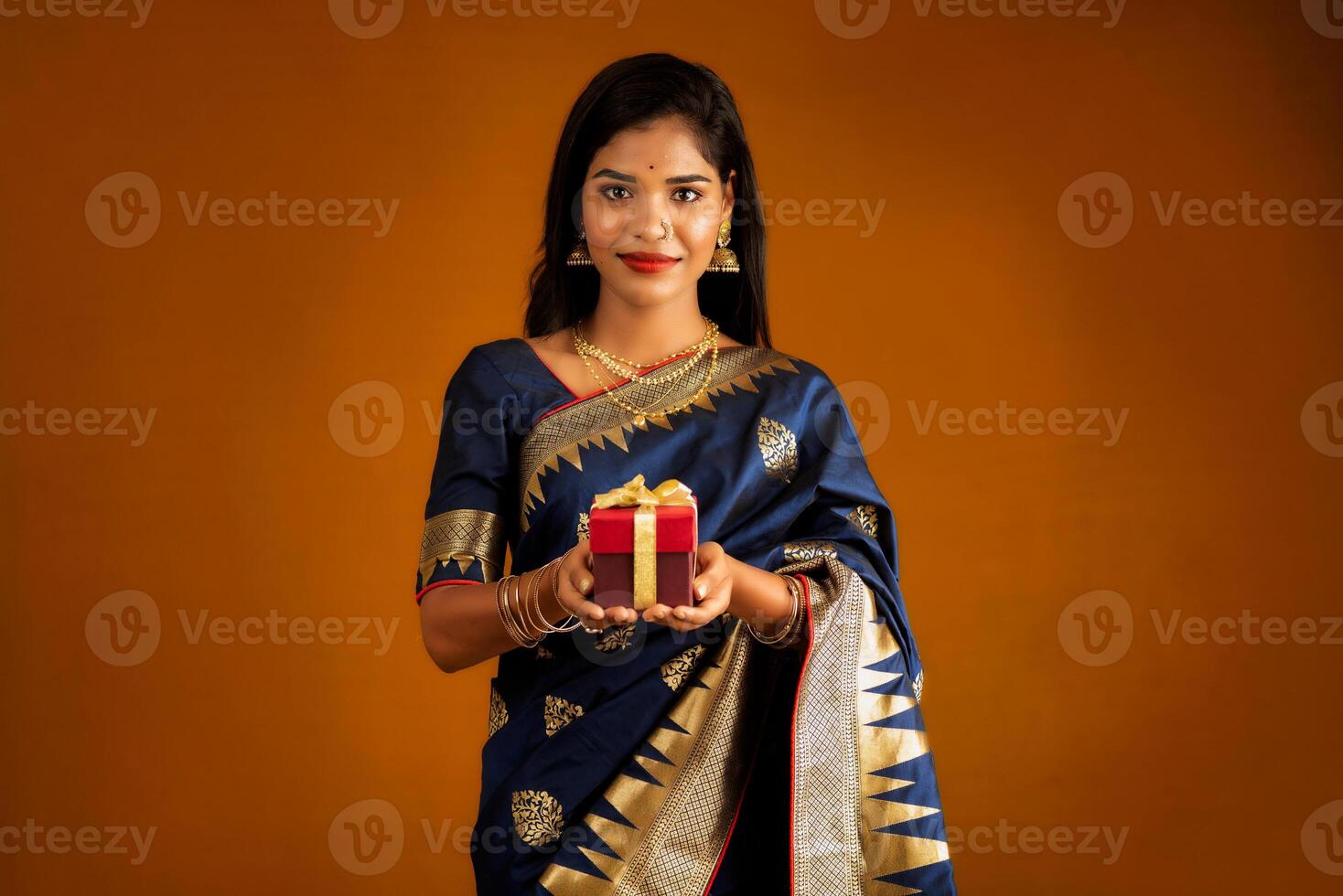 Portrait of young happy smiling woman or Girl holding gift box. photo