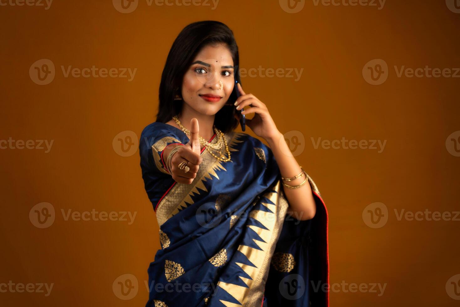 Young beautiful girl or woman holding and using smartphone or mobile or tablet phone photo
