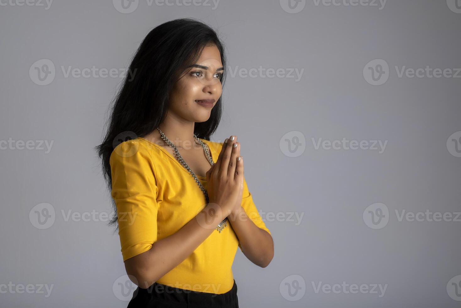 Beautiful Indian girl with welcome expression or inviting or greeting Namaste photo