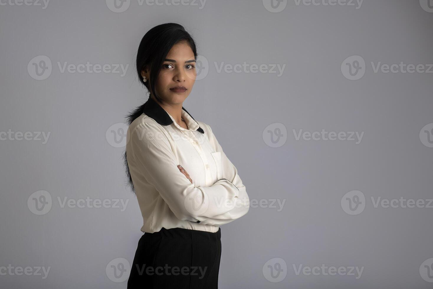 Portrait of a young girl woman posing on gray background photo