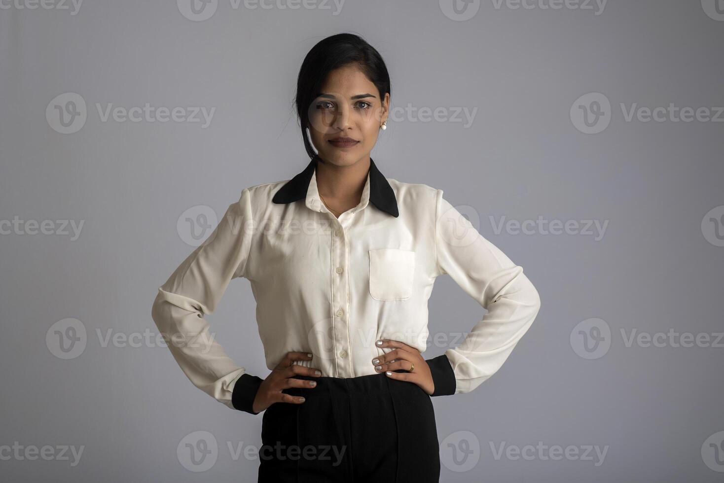 Portrait of a young girl woman posing on gray background photo