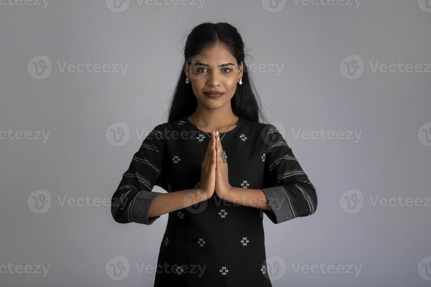 Beautiful Indian girl with welcome expression or inviting or greeting Namaste photo