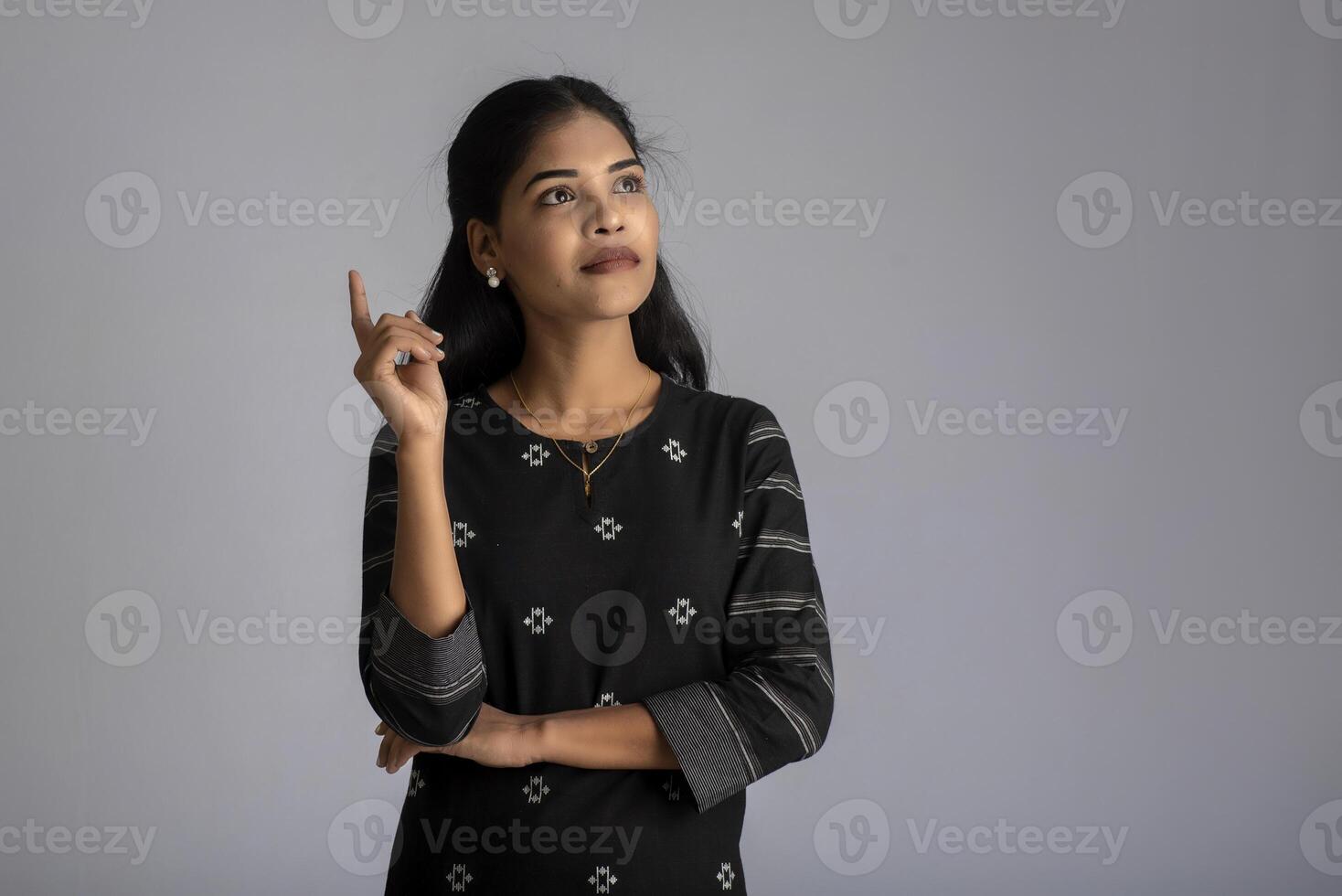 Portrait of a young girl posing on gray background photo
