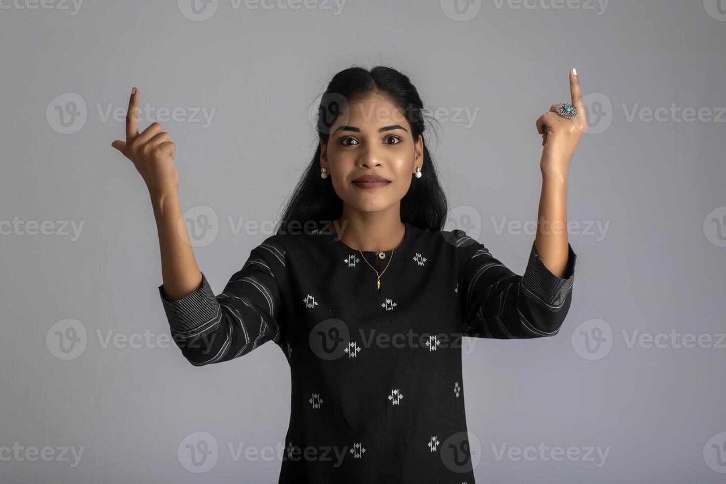 Portrait of a young girl posing on gray background photo