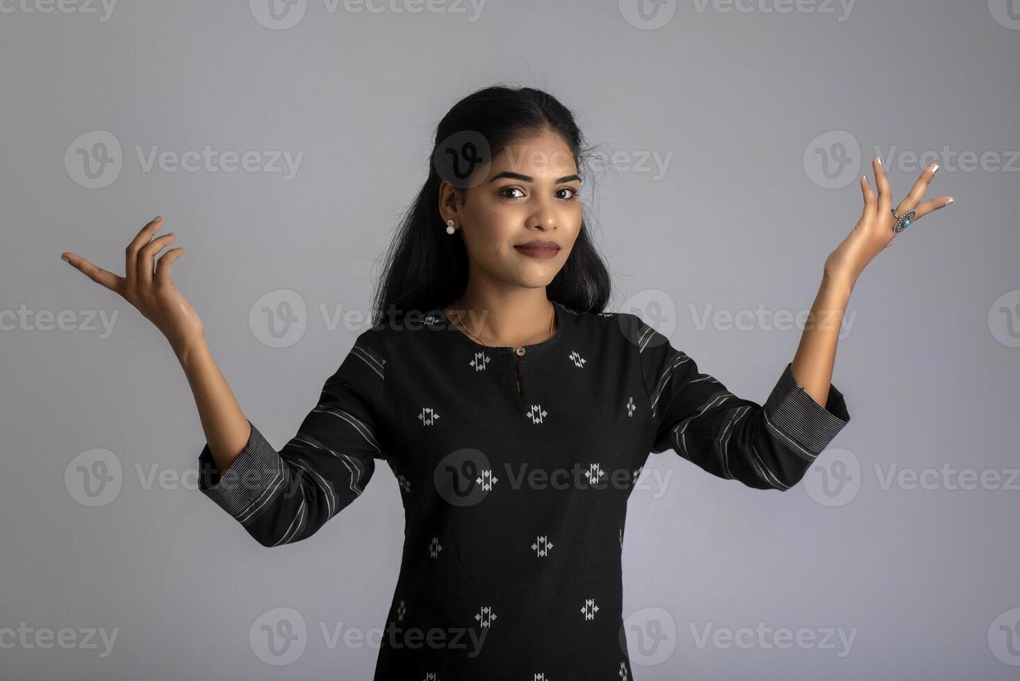Portrait of a young girl posing on gray background photo