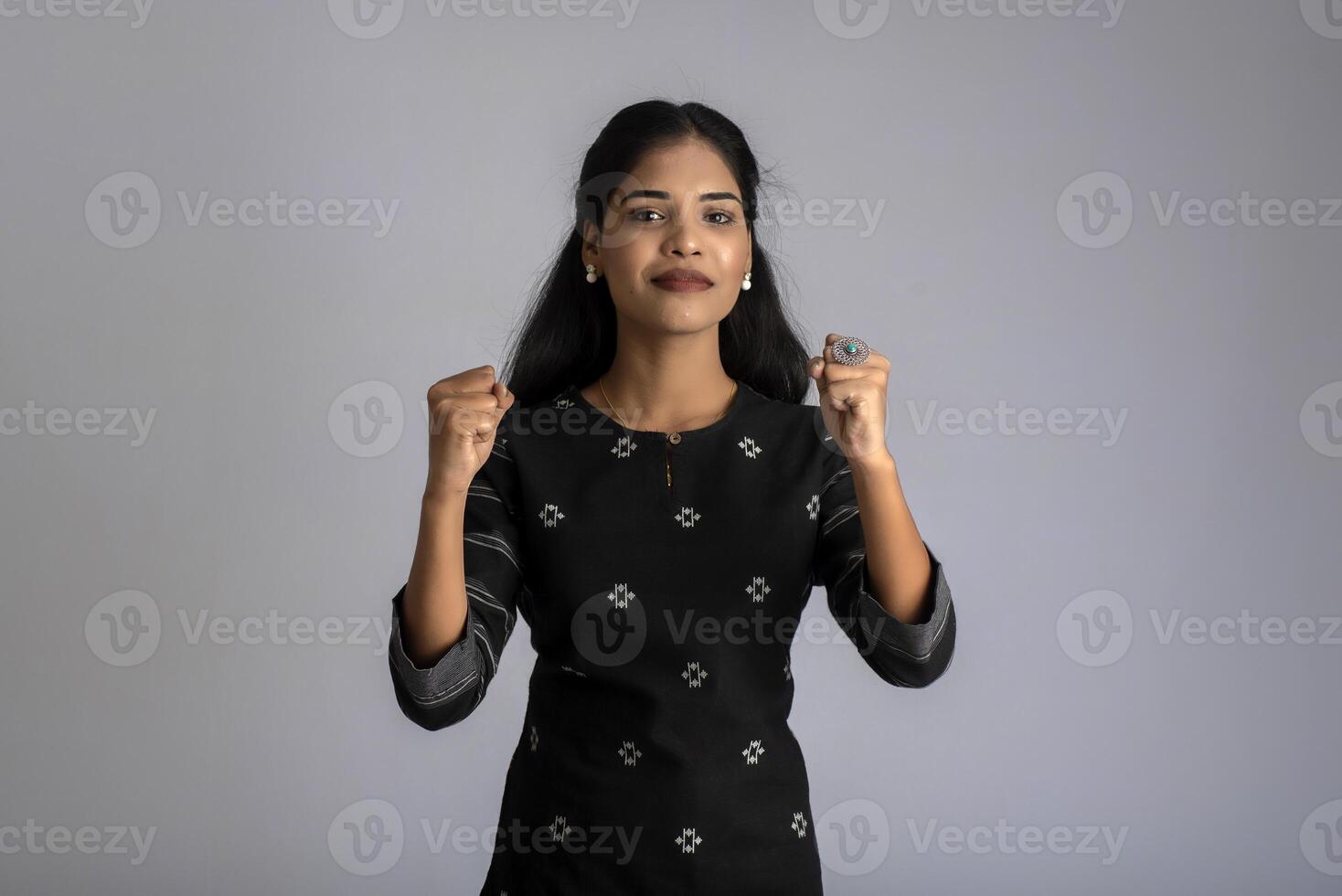 Portrait of a young girl posing on gray background photo