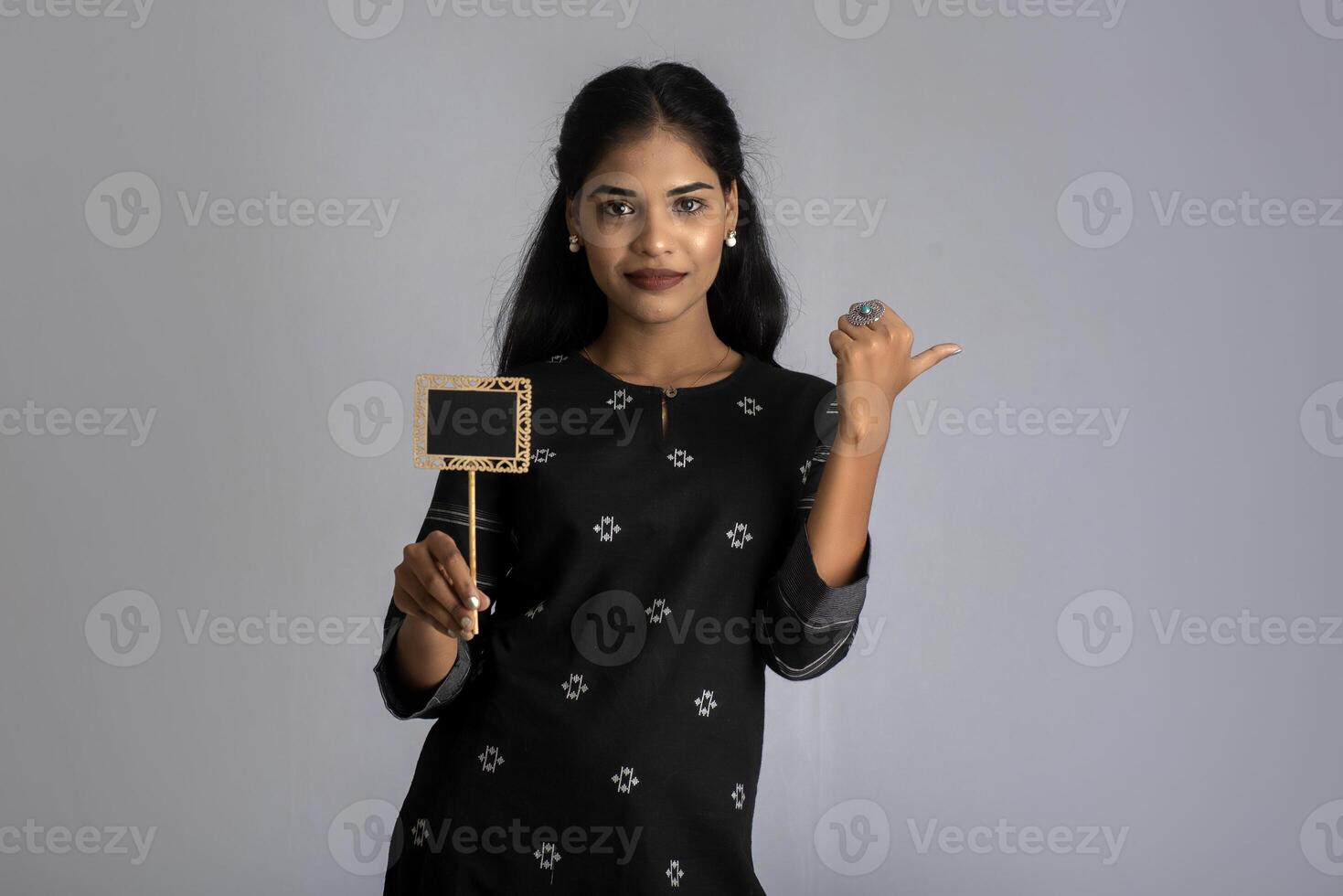 A woman holding a black and white board photo