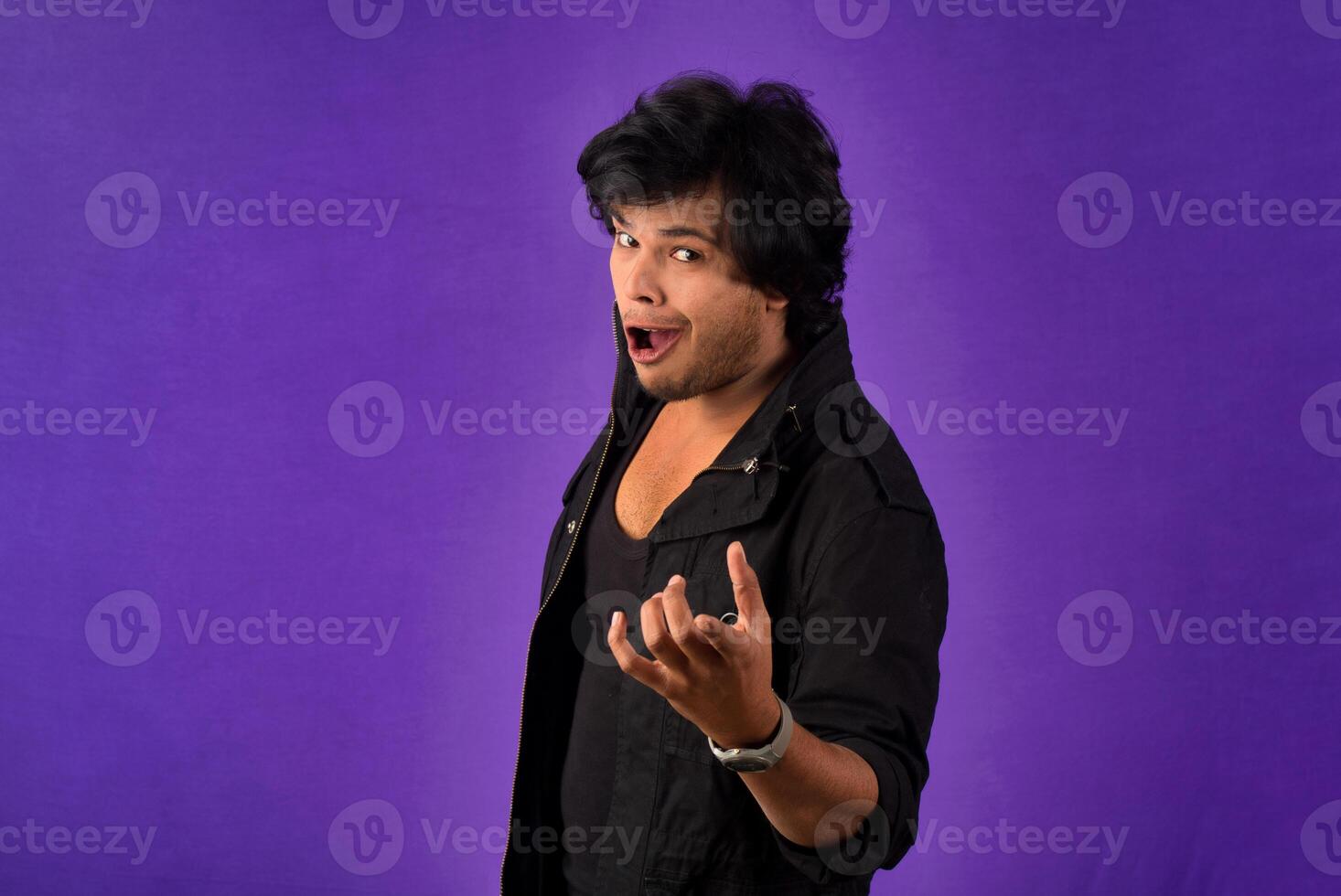 Young handsome man over dark background afraid and shocked with surprise and amazed expression, fear and excited face. photo