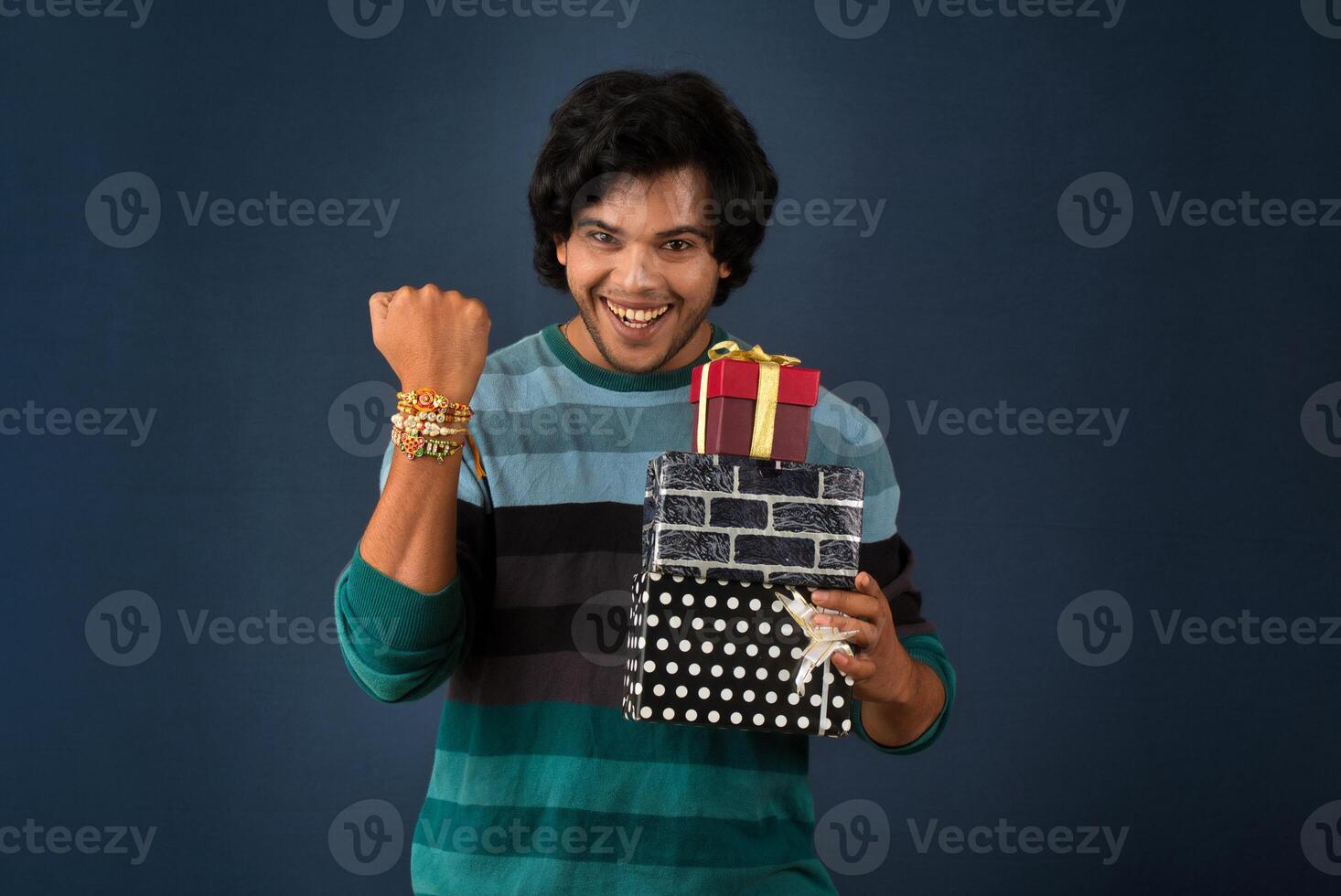 Young men showing Rakhi on his hand with gift box on the occasion of Raksha Bandhan festival photo