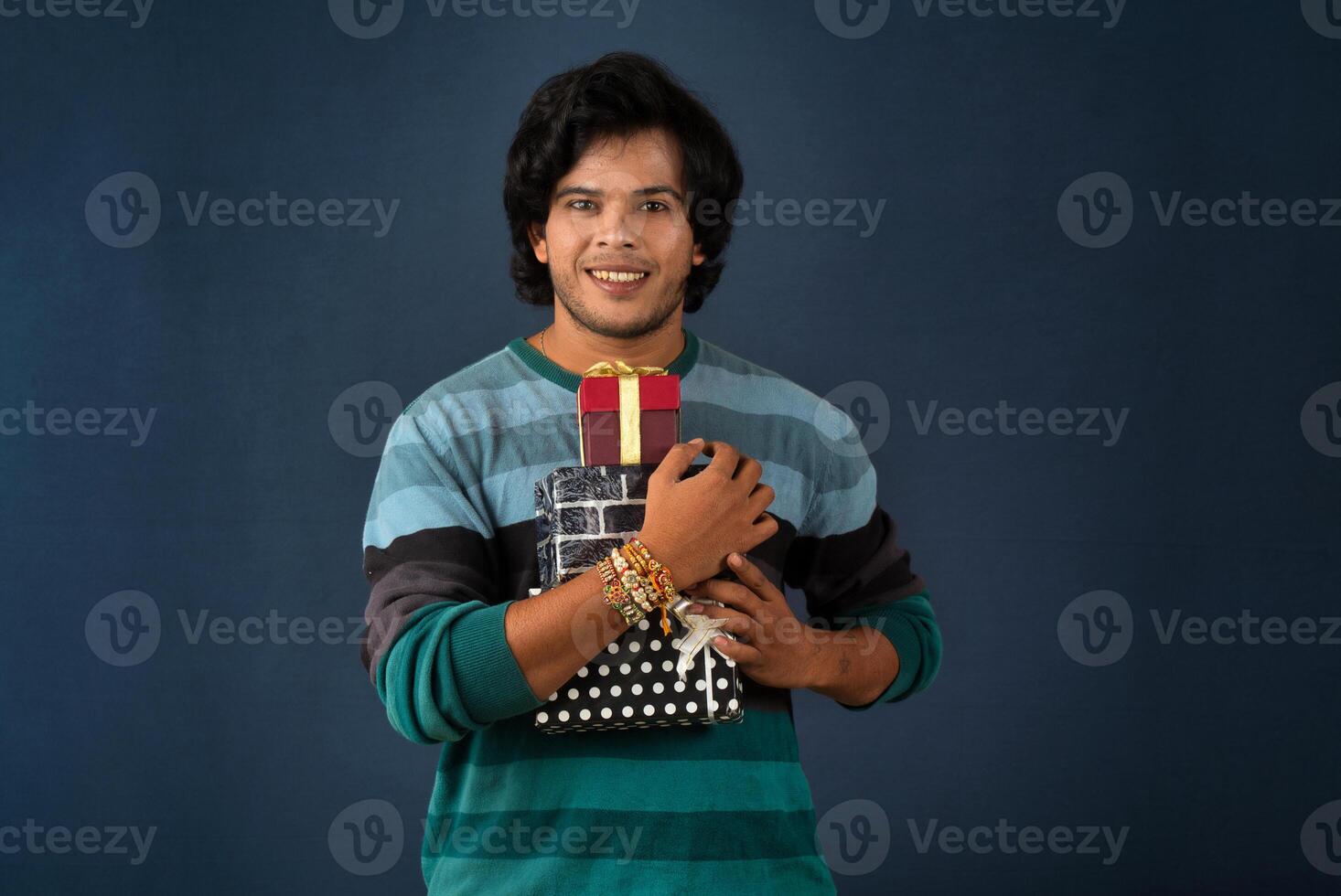 Young men showing Rakhi on his hand with gift box on the occasion of Raksha Bandhan festival photo