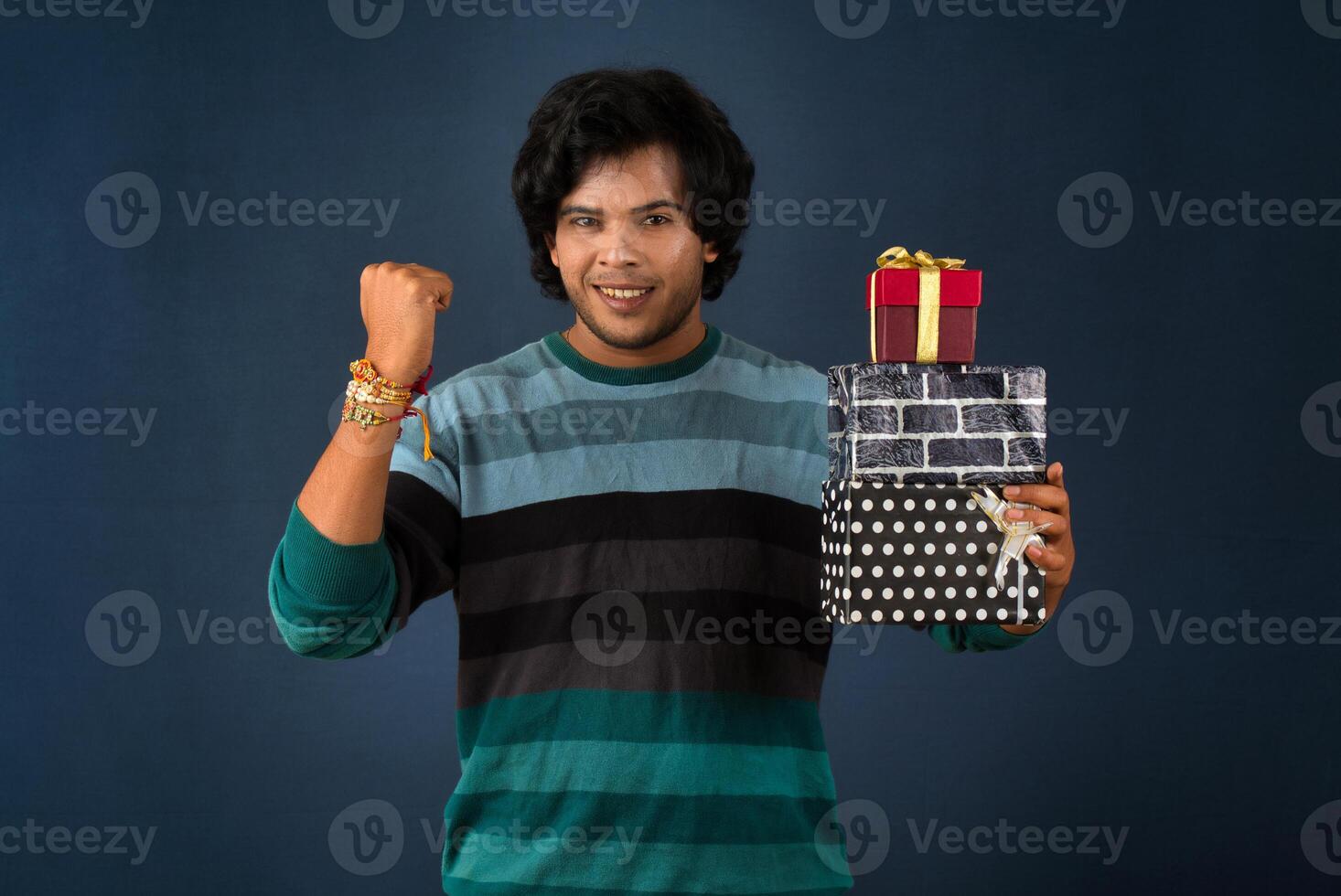 Young men showing Rakhi on his hand with gift box on the occasion of Raksha Bandhan festival photo