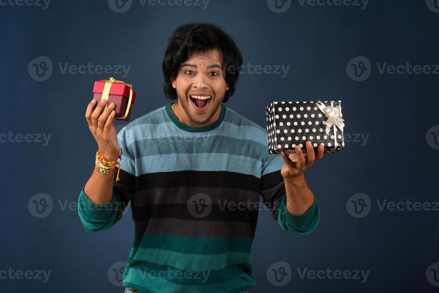 Young men showing Rakhi on his hand with gift box on the occasion of Raksha Bandhan festival photo