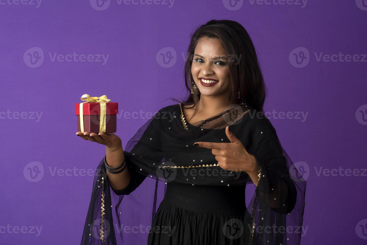 Portrait of young happy smiling woman or Girl holding gift box. photo