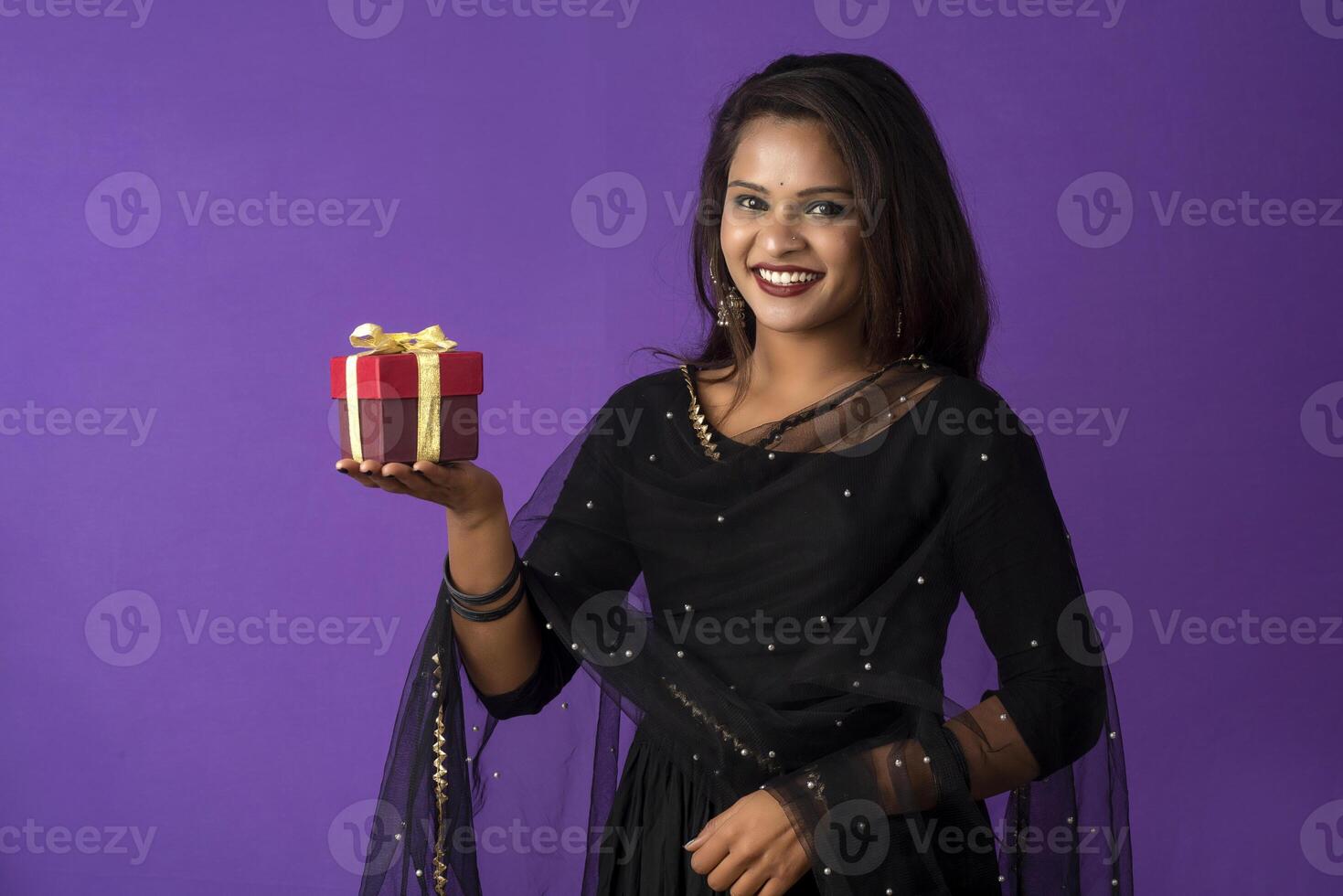 Portrait of young happy smiling woman or Girl holding gift box. photo