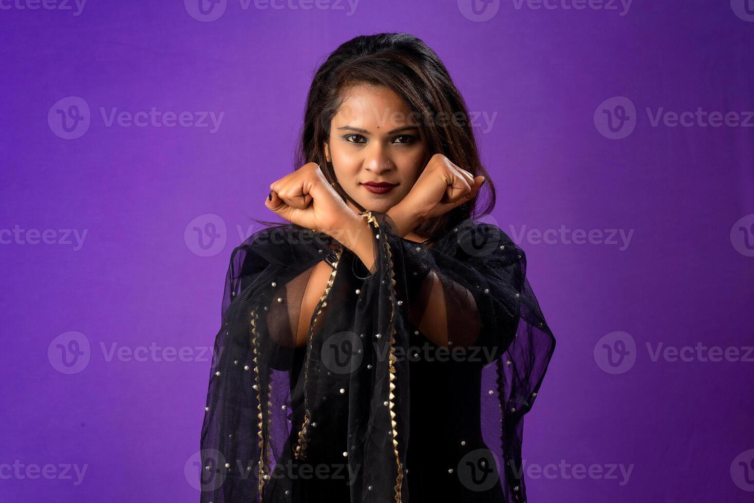 Definitely no, prohibited access Portrait of a girl crossing hands and showing palm, stop gesture, warning of end finish, forbidden way. indoor studio shot on purple background photo