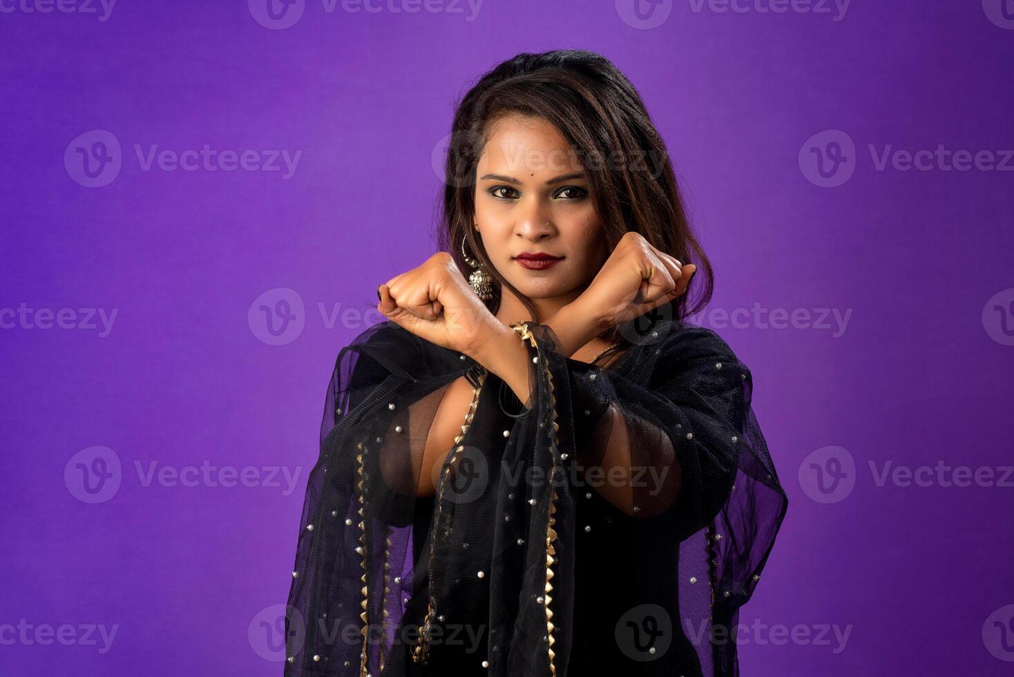 Definitely no, prohibited access Portrait of a girl crossing hands and showing palm, stop gesture, warning of end finish, forbidden way. indoor studio shot on purple background photo