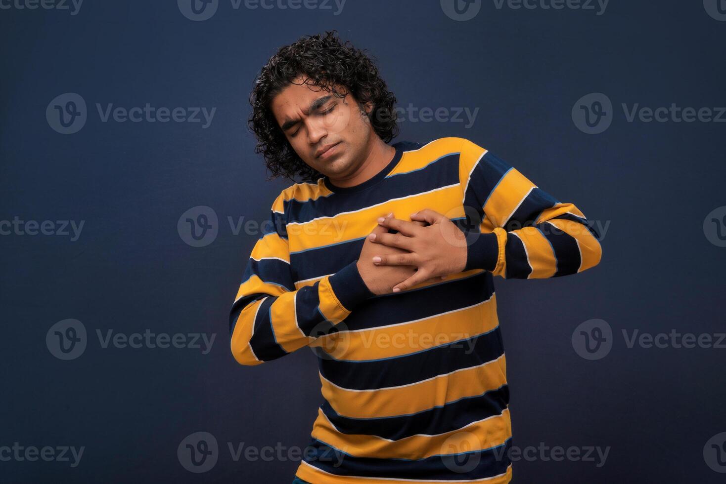 A man with his hands on his chest photo