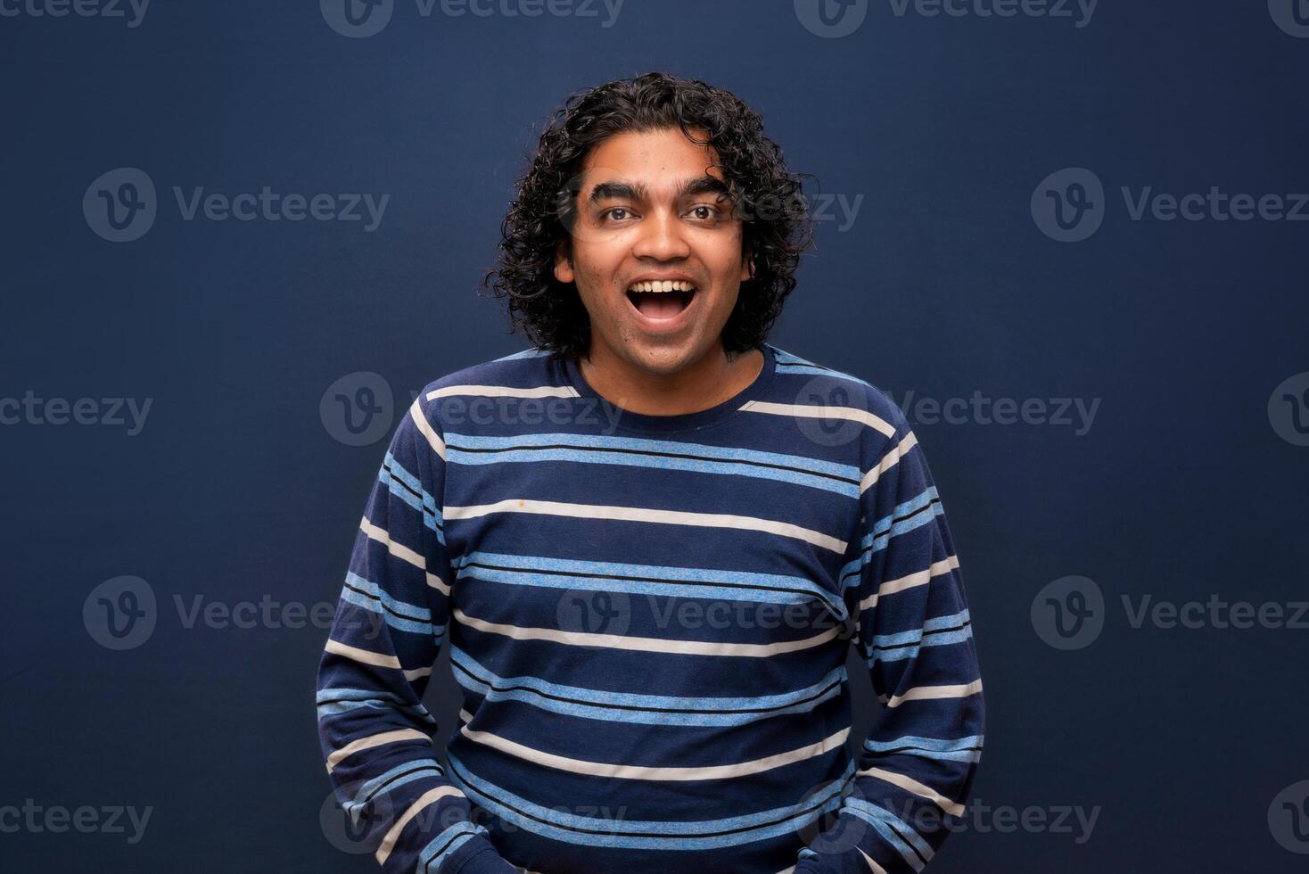 Young handsome man over gray background afraid and shocked with surprise and amazed expression, fear and excited face. photo