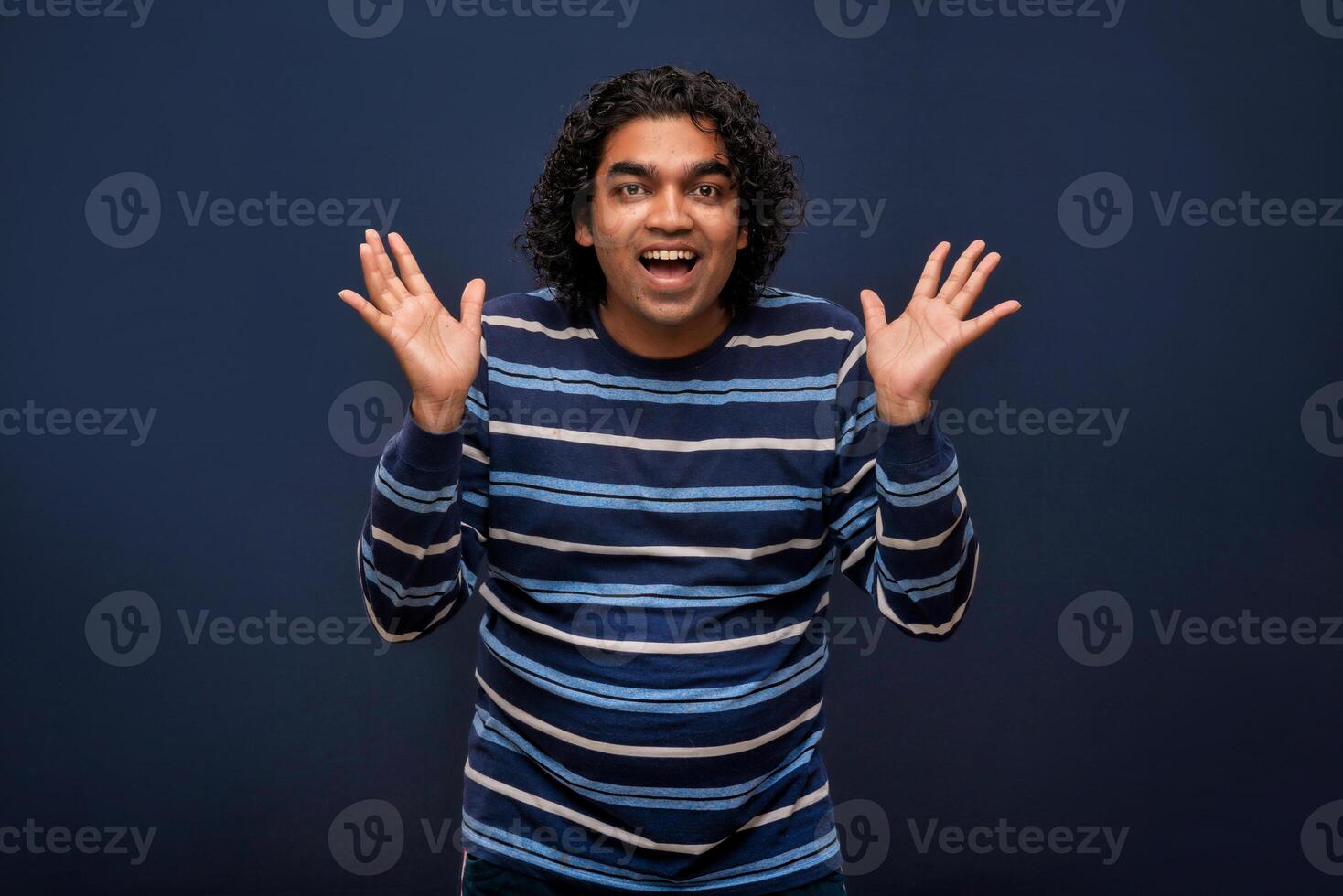 Young handsome man over gray background afraid and shocked with surprise and amazed expression, fear and excited face. photo