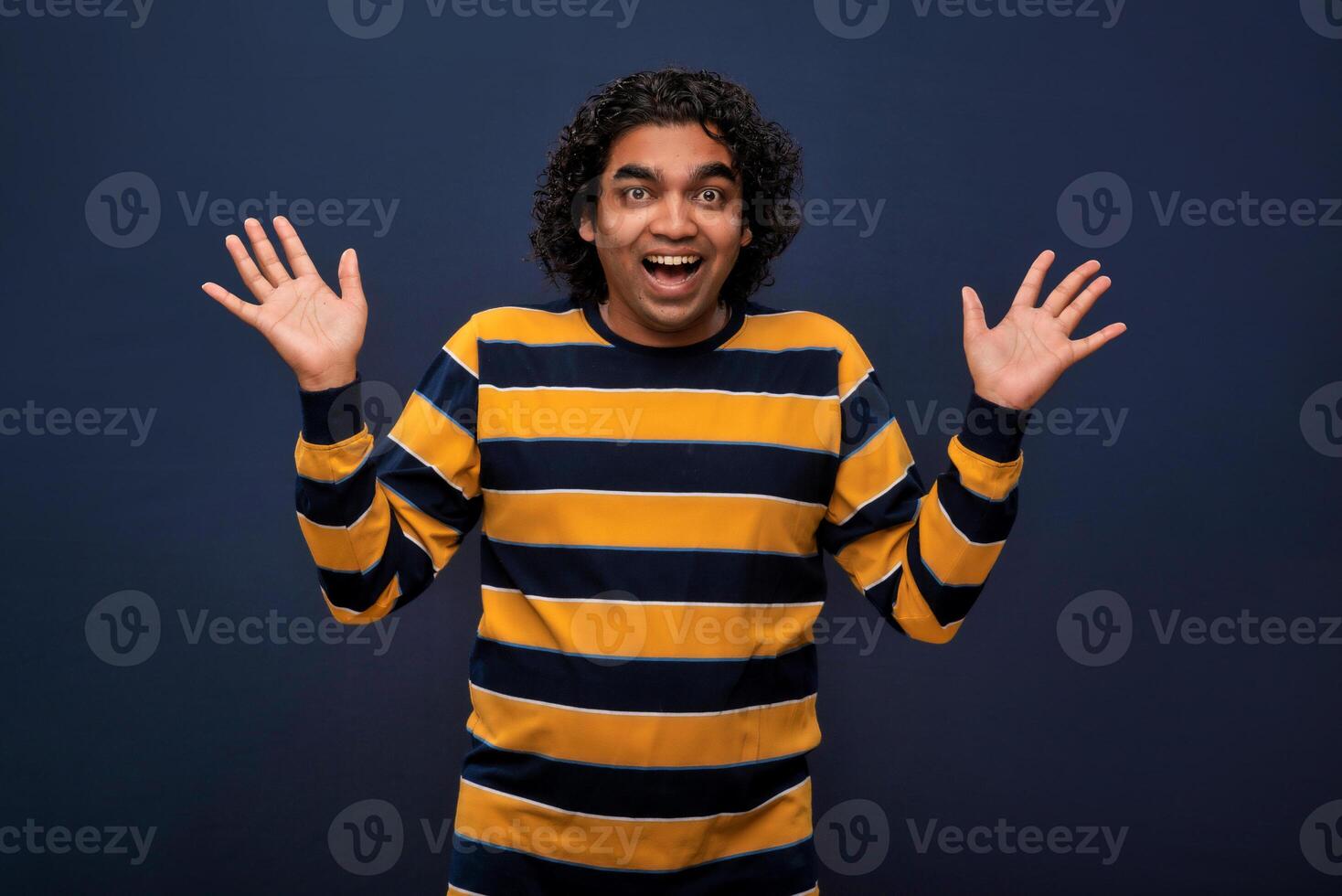 Young handsome man over gray background afraid and shocked with surprise and amazed expression, fear and excited face. photo