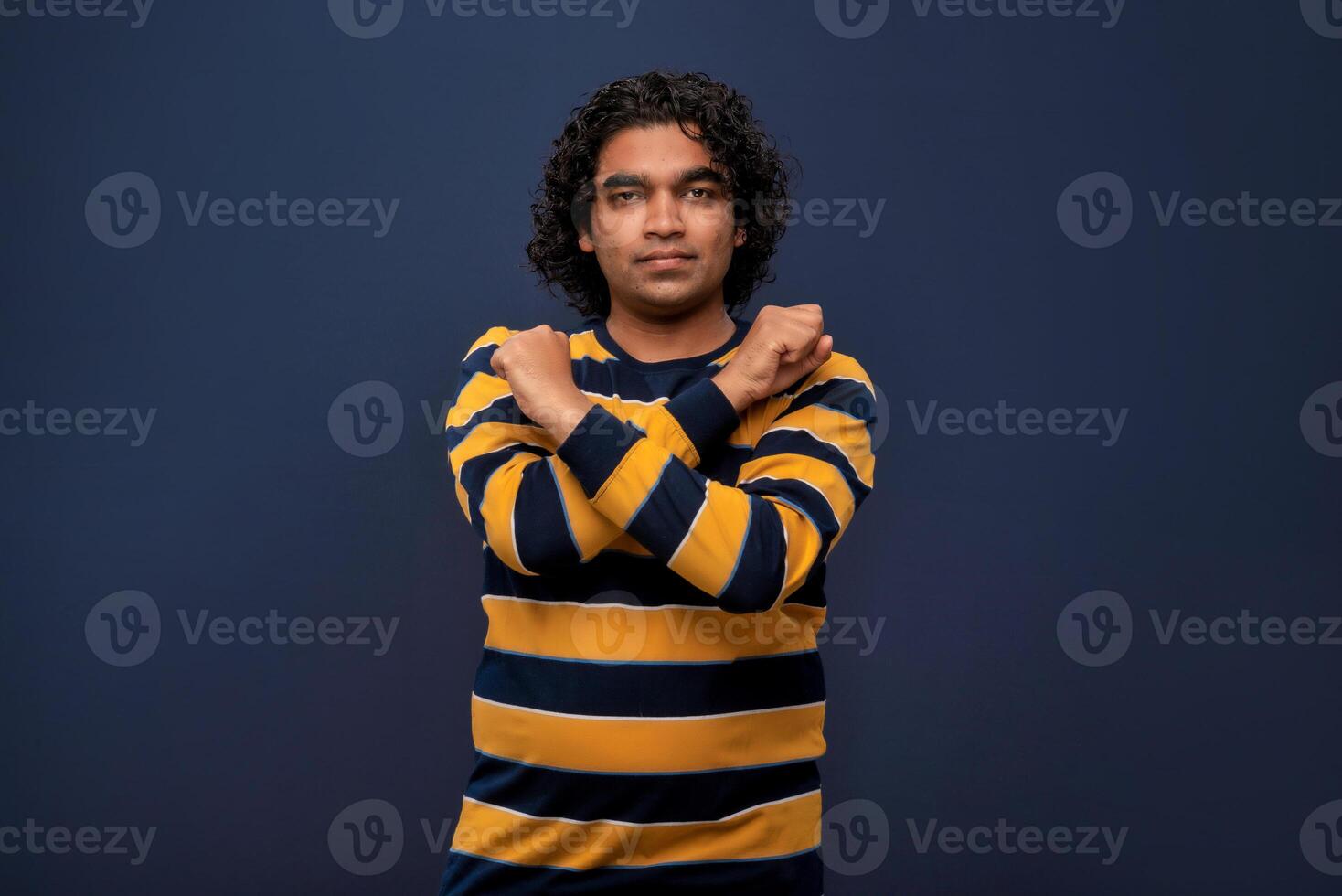 Portrait of a man crossing hands and showing palm, stop gesture, warning of end finish, forbidden way. indoor studio shot on gray background photo