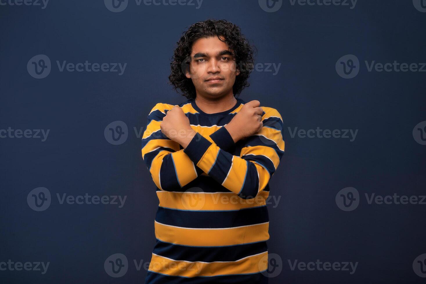 Portrait of a man crossing hands and showing palm, stop gesture, warning of end finish, forbidden way. indoor studio shot on gray background photo