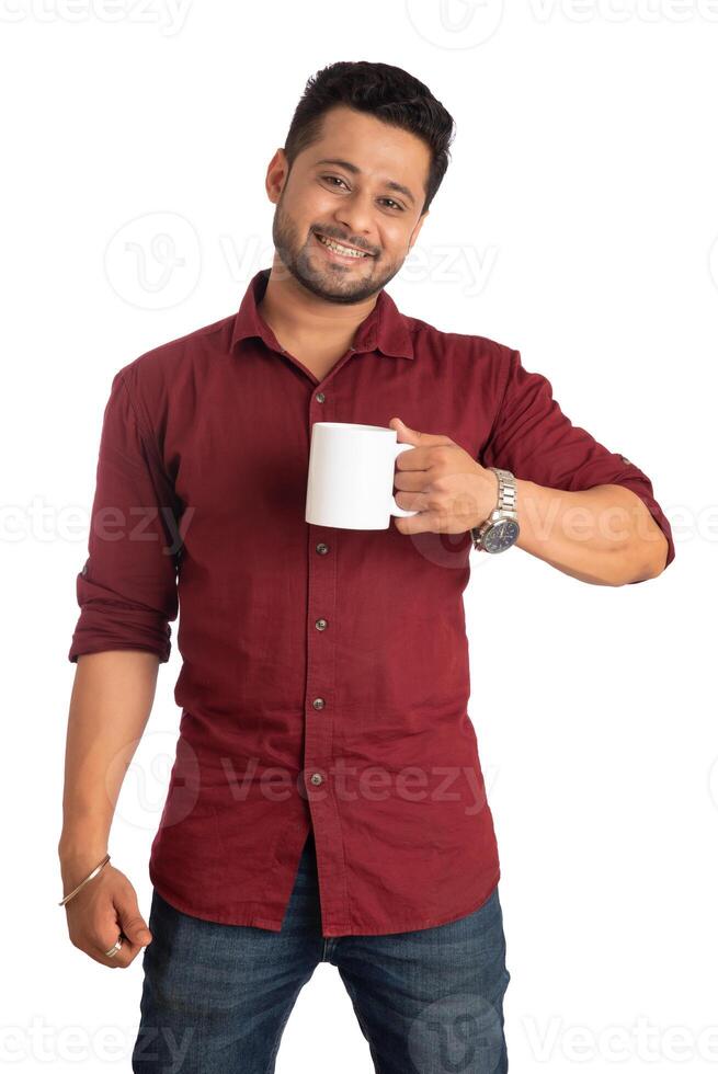 Handsome smiling man with cup of coffee or tea isolated on white background photo
