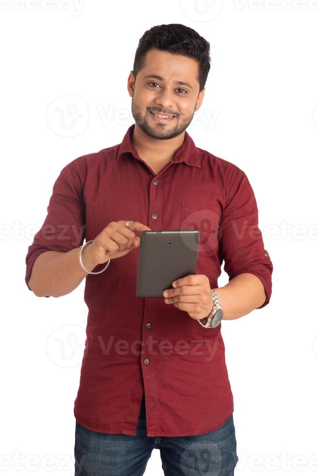 Young handsome man holding and using smartphone or mobile or tablet phone on a white background photo