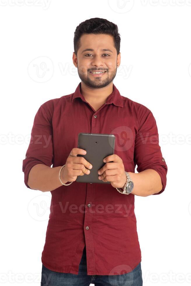 Young handsome man holding and using smartphone or mobile or tablet phone on a white background photo