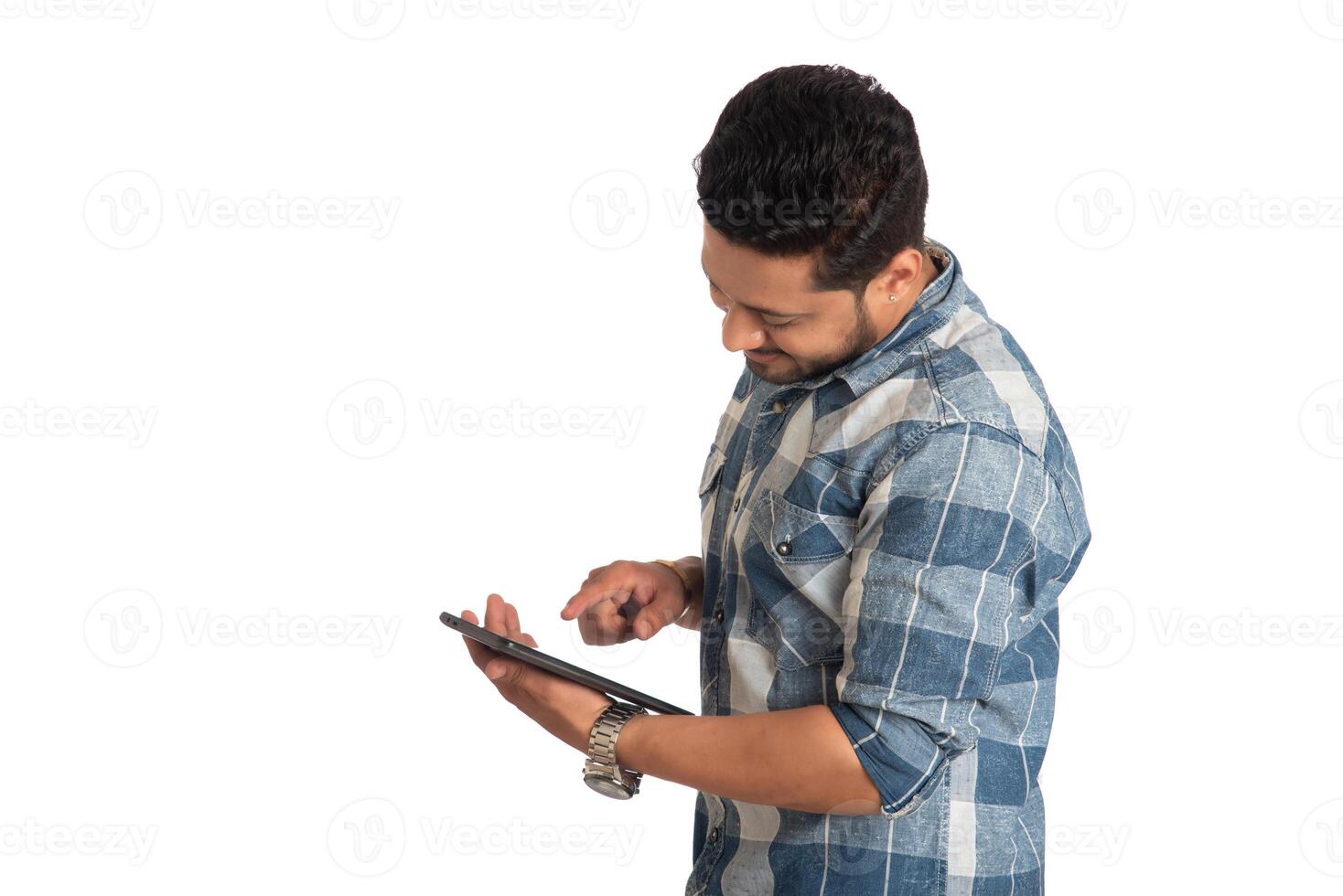 Young handsome man holding and using smartphone or mobile or tablet phone on a white background photo
