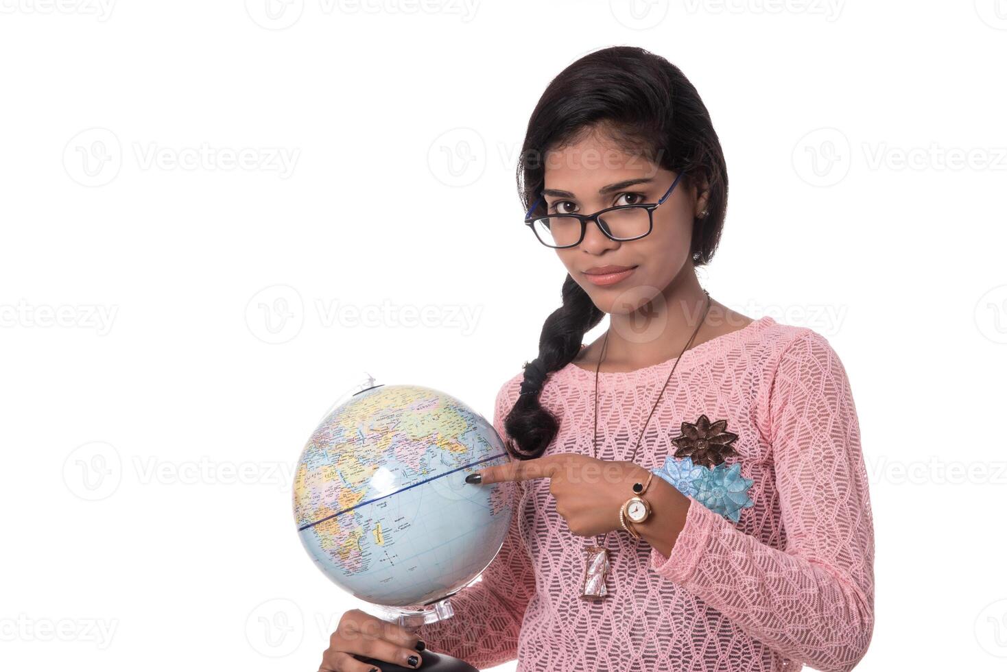 Beautiful Girl holding a world globe isolated on a white background photo