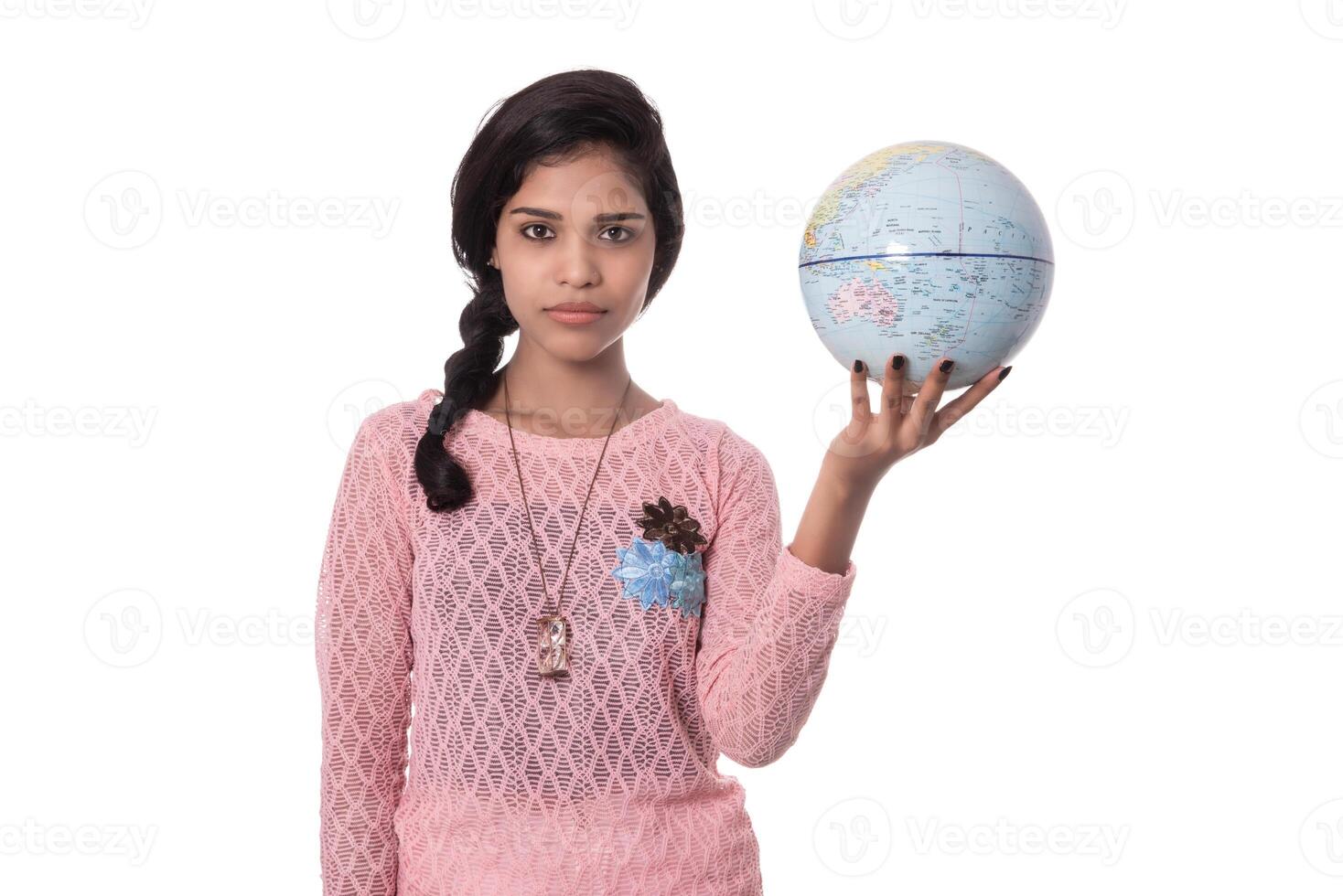 Beautiful Girl holding a world globe isolated on a white background photo