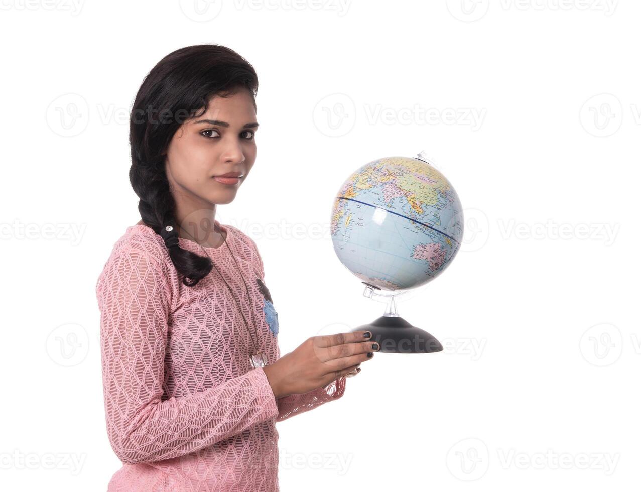 Beautiful Girl holding a world globe isolated on a white background photo