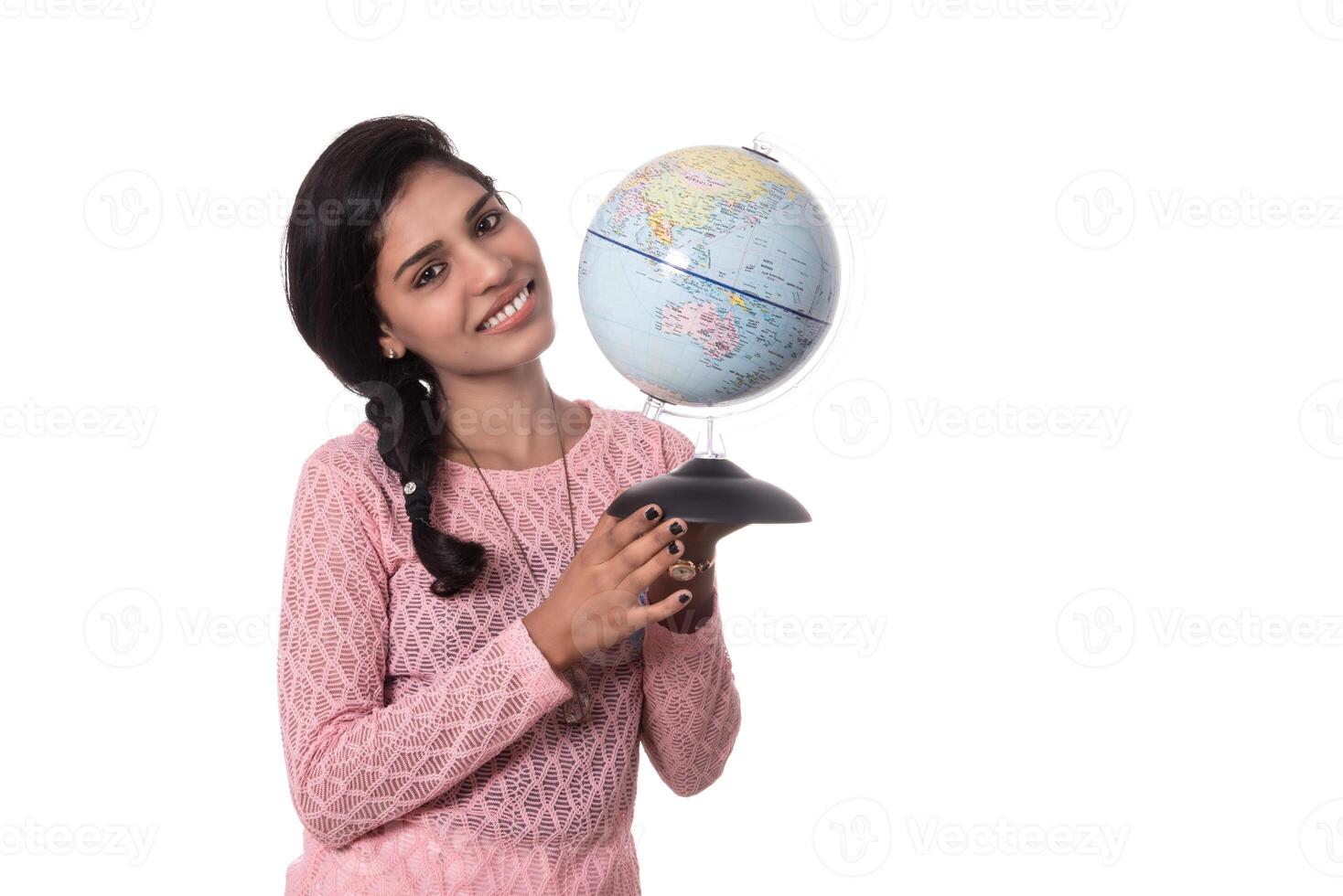 Beautiful Girl holding a world globe isolated on a white background photo