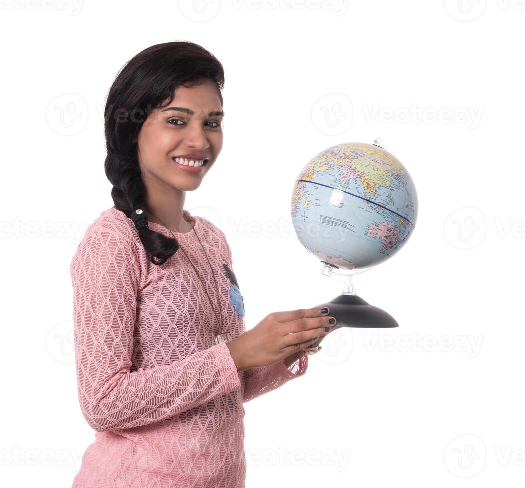 Beautiful Girl holding a world globe isolated on a white background photo