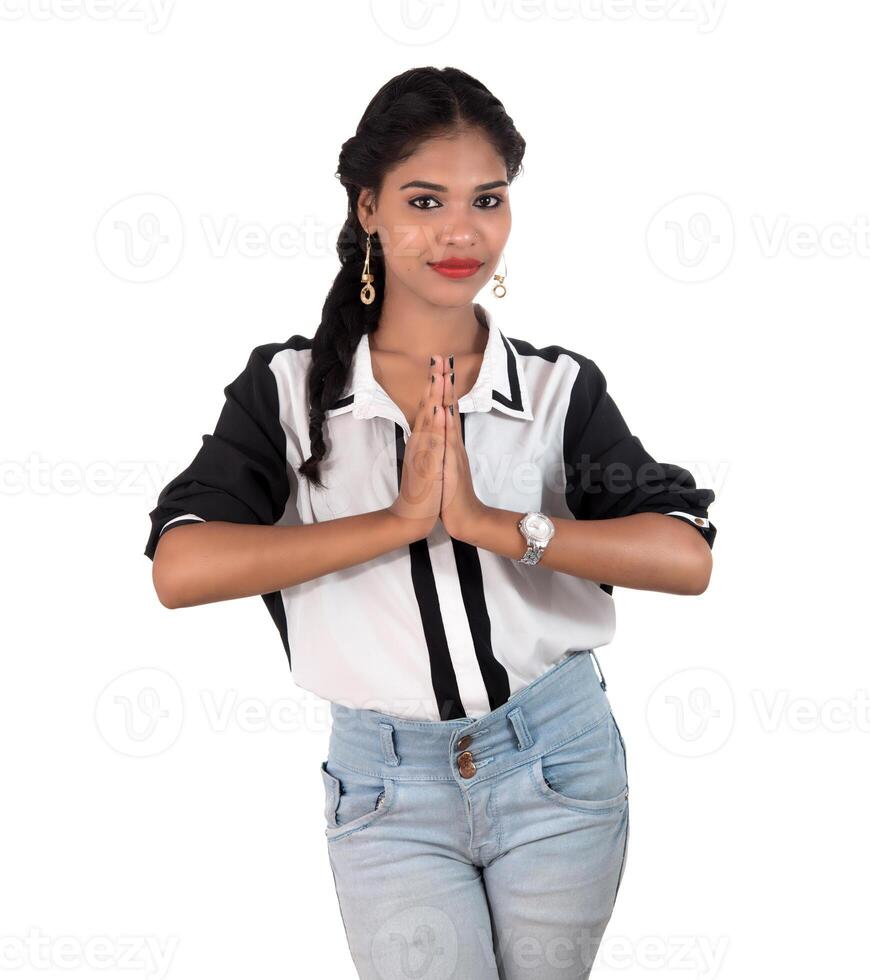 Beautiful Indian girl with welcome expression inviting, greeting Namaste photo