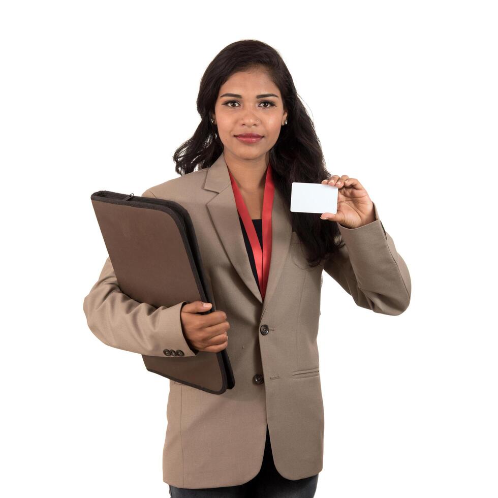 Smiling business woman holding a blank business card or ID card over white background photo