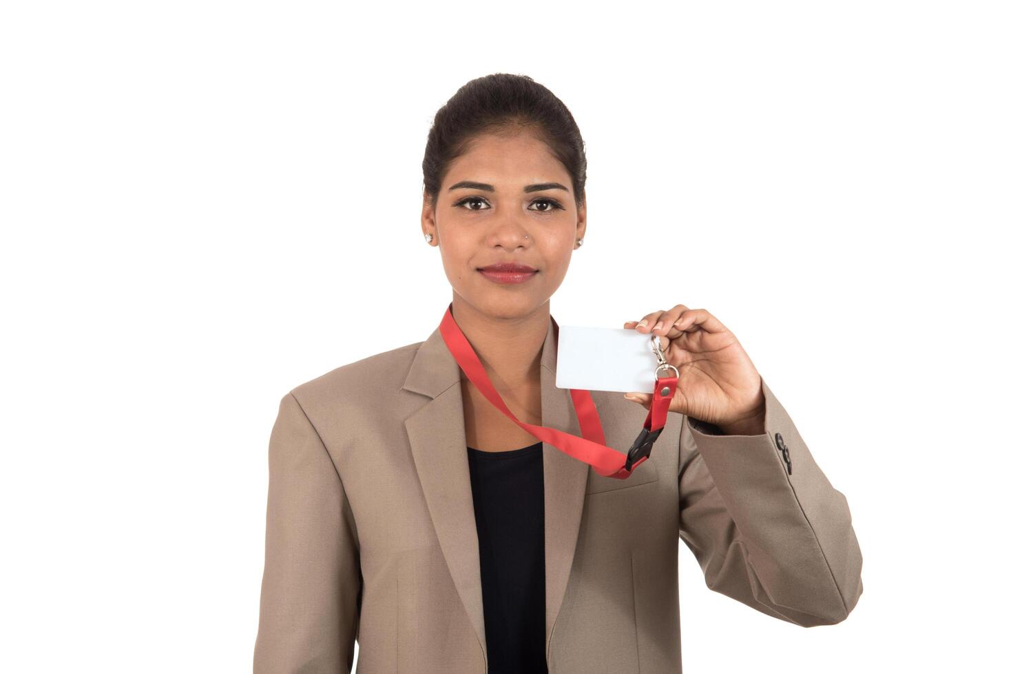 Smiling business woman holding a blank business card or ID card over white background photo