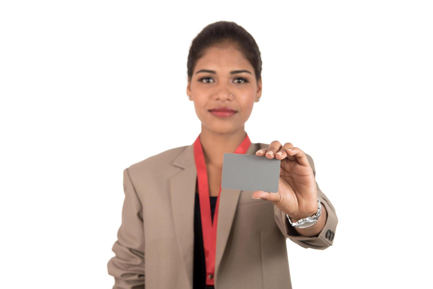 Smiling business woman holding a blank business card or ID card over white background photo