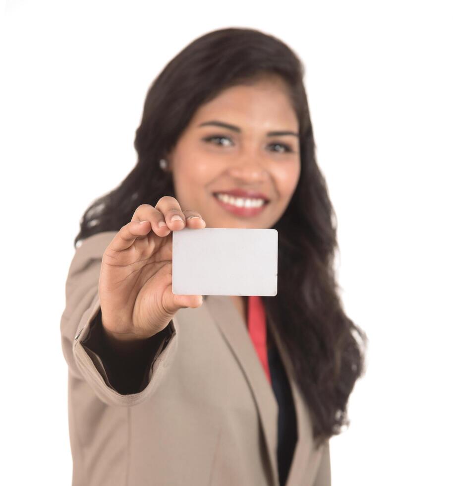Smiling business woman holding a blank business card or ID card over white background photo