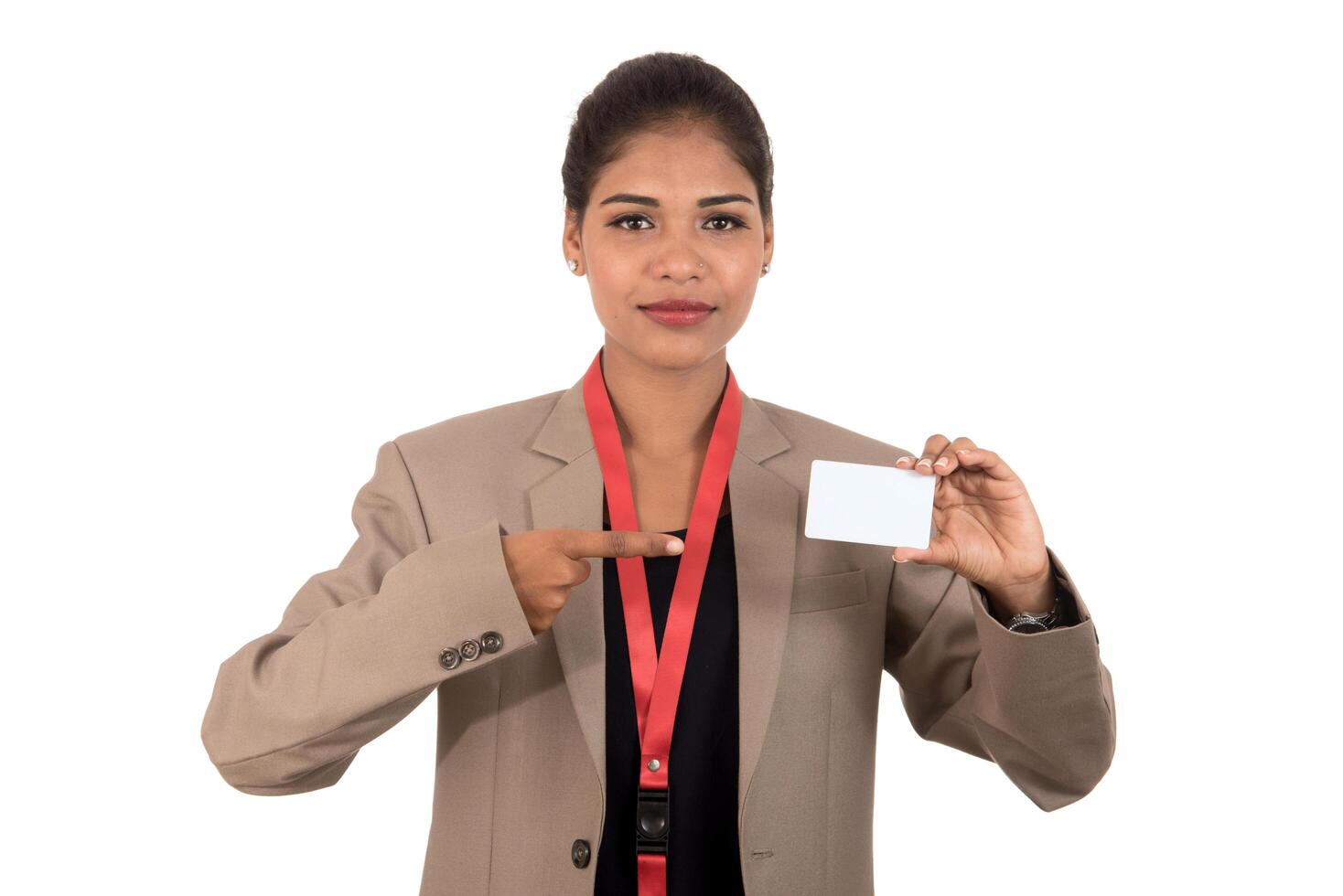 Smiling business woman holding a blank business card or ID card over white background photo