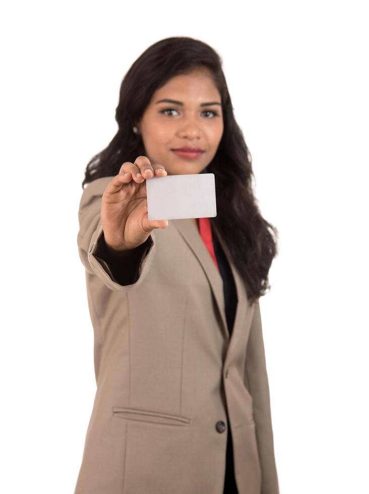 Smiling business woman holding a blank business card or ID card over white background photo