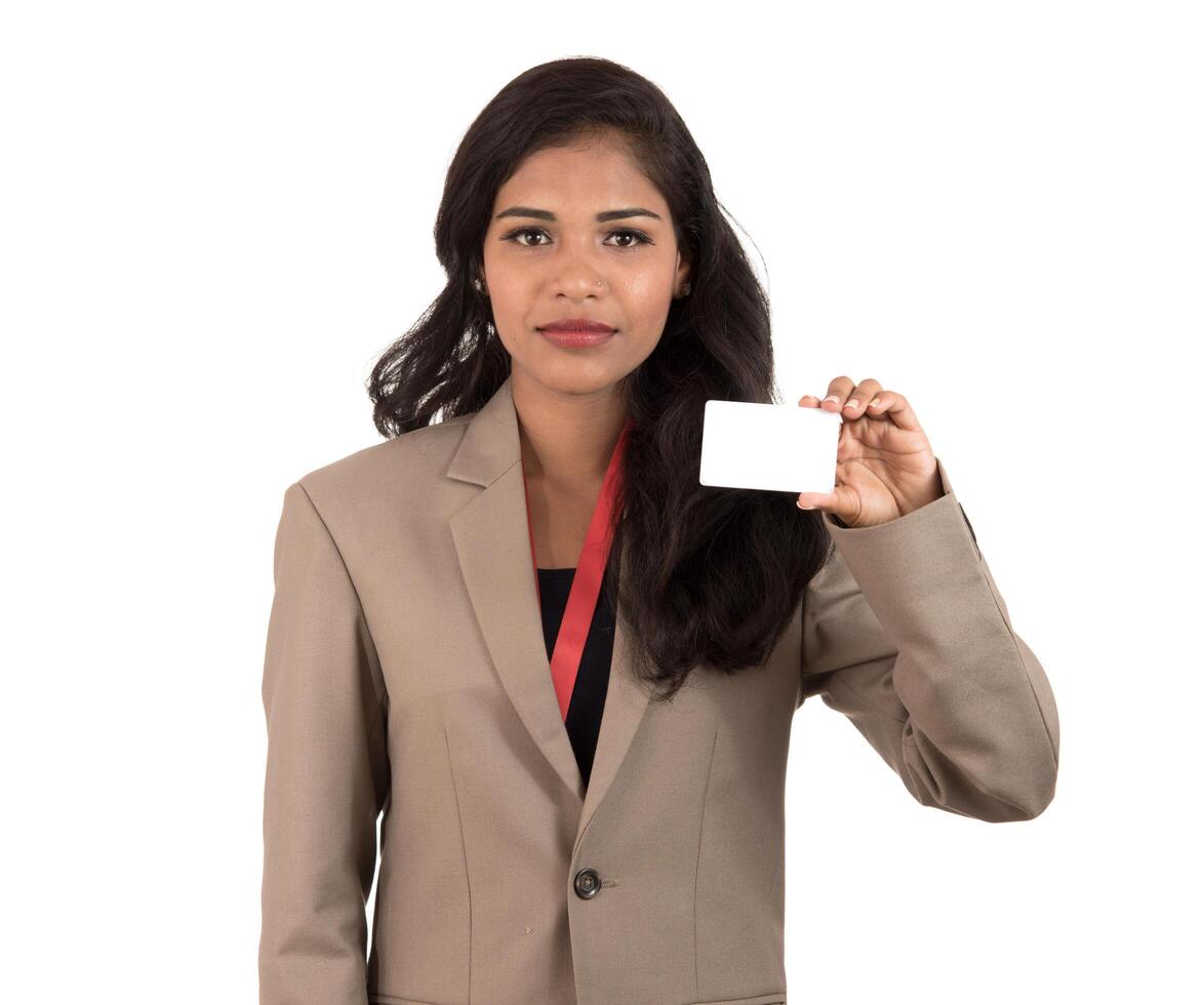 Smiling business woman holding a blank business card or ID card over white background photo