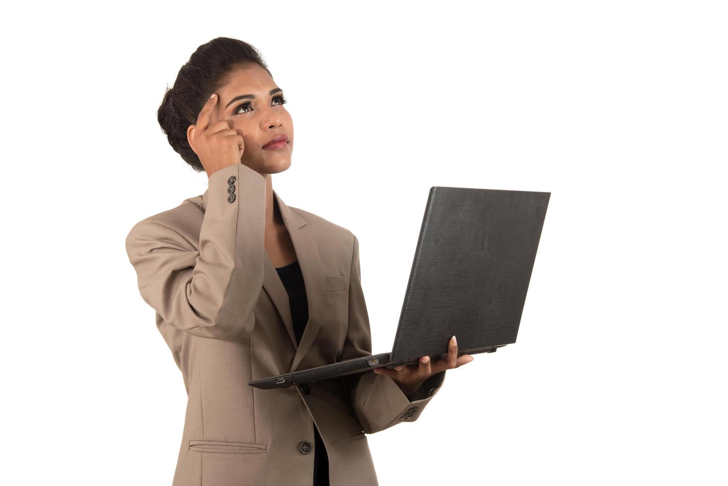 Thoughtful woman with a laptop - isolated over a white background photo