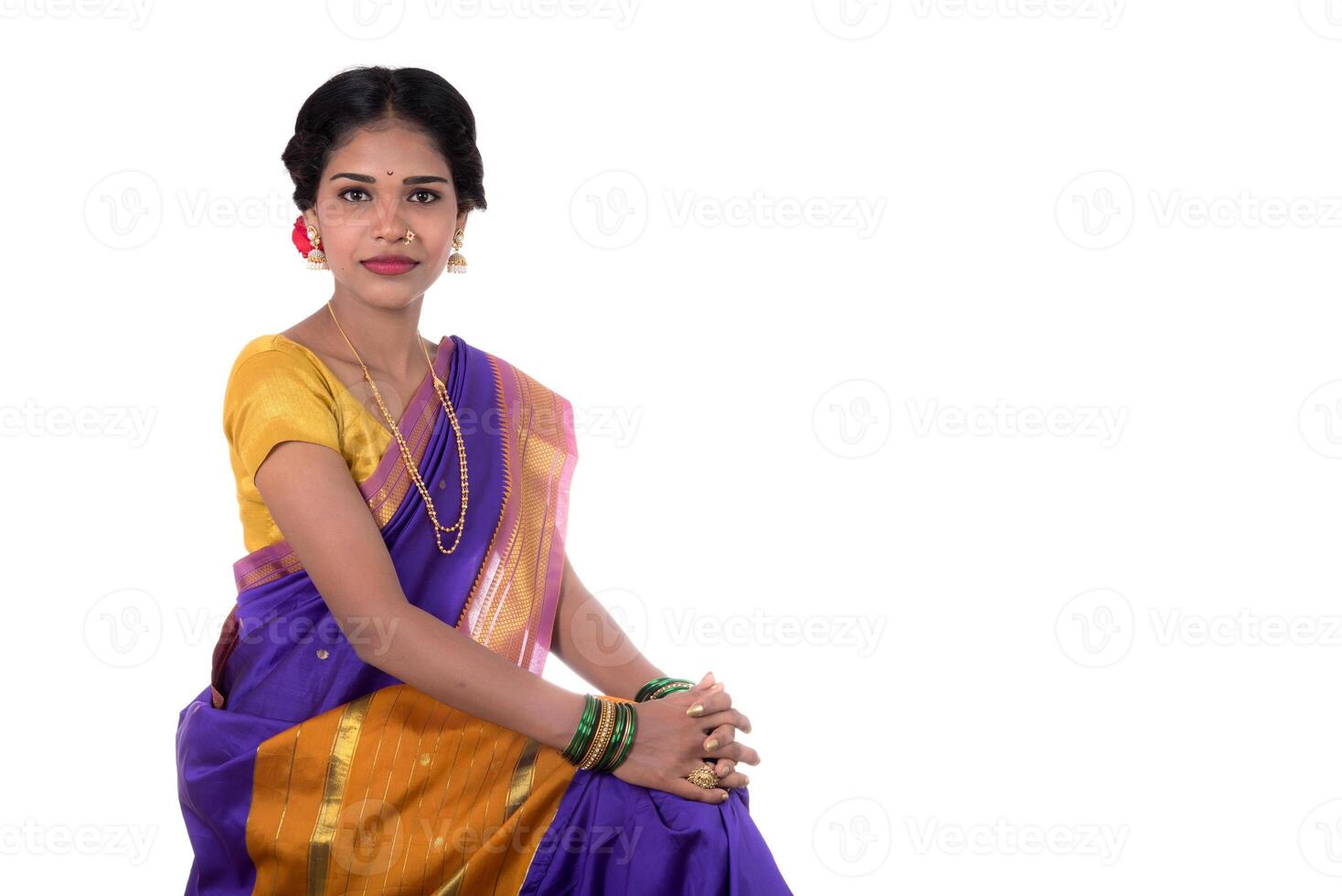 Beautiful Indian young girl posing in traditional Indian saree on white background. photo