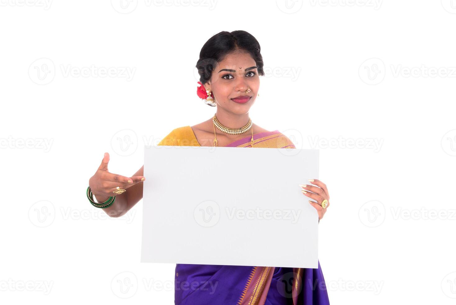 Traditional Girl holding and showing blank white sign board photo