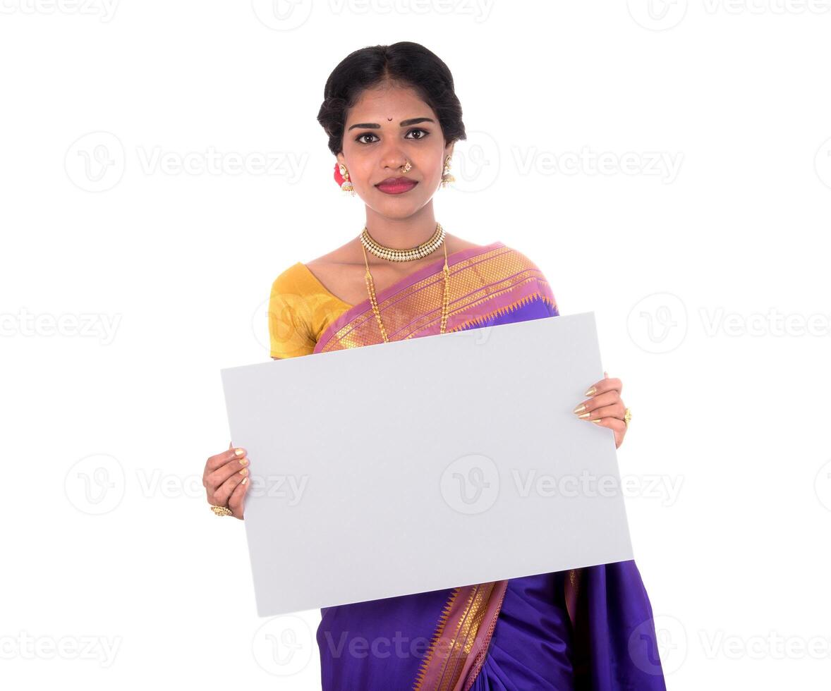 Traditional Girl holding and showing blank white sign board photo