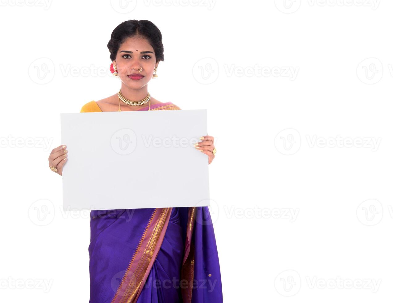 Traditional Girl holding and showing blank white sign board photo