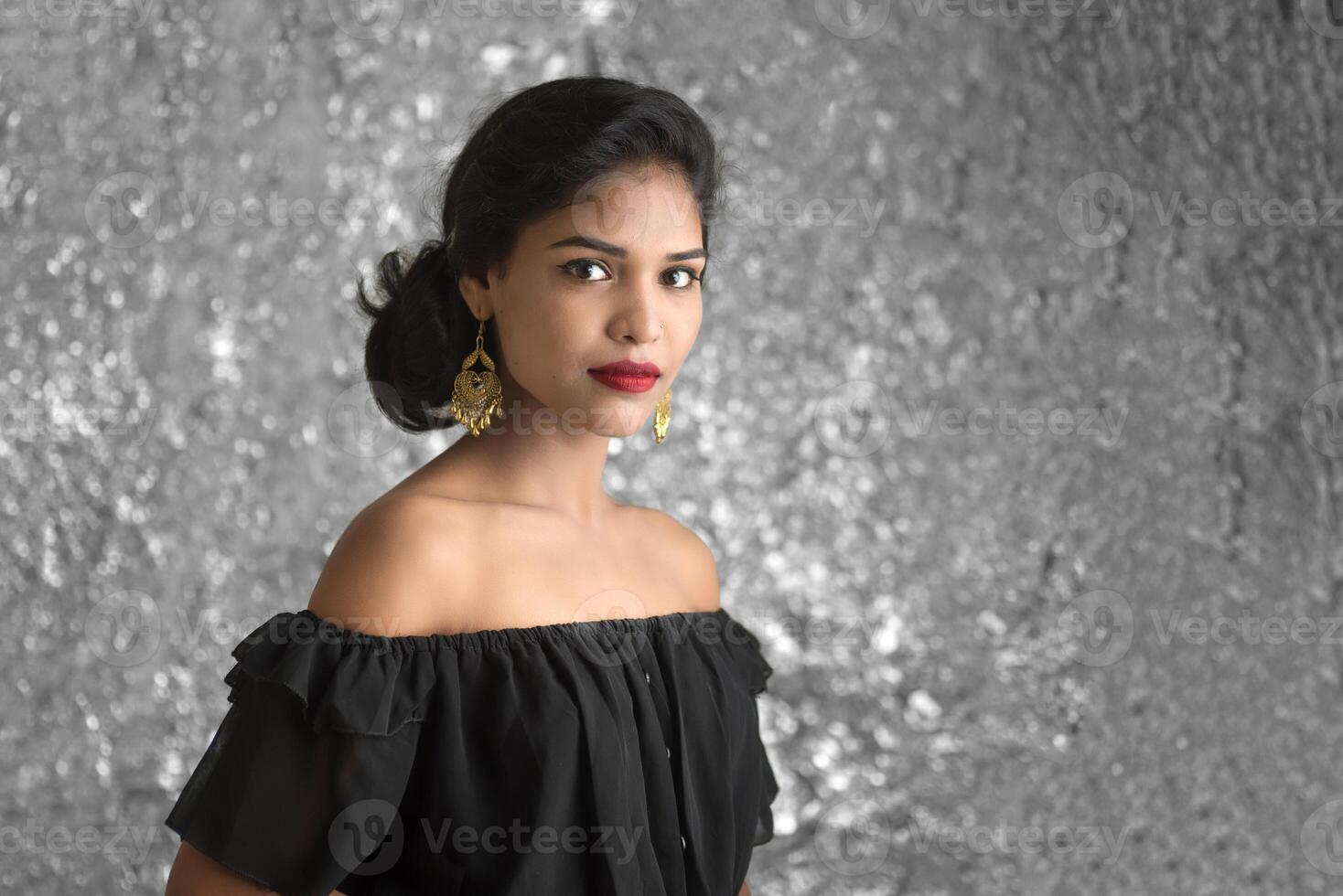 Portrait of beautiful young Girl. Closeup face of a pretty Indian model on texture background photo
